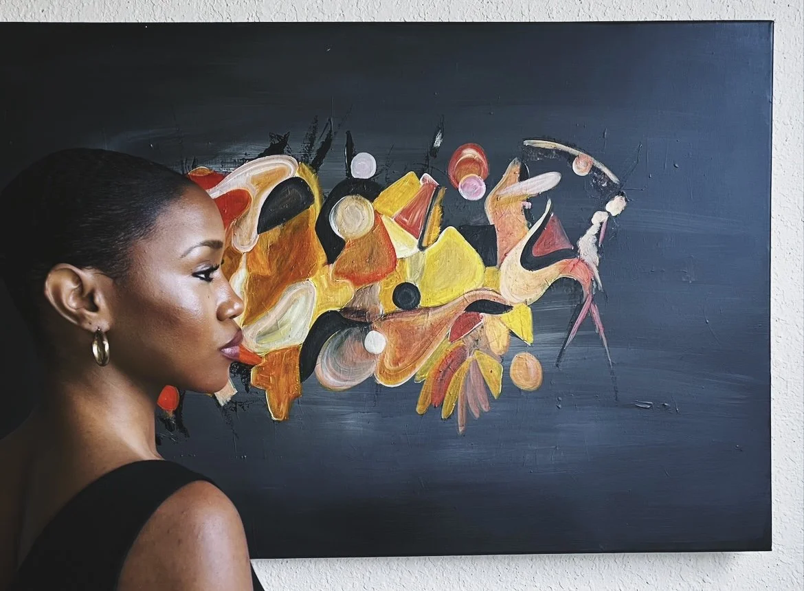 A woman with dark hair and earrings looking at an abstract painting with yellow, red, black, and white shapes on a dark background.