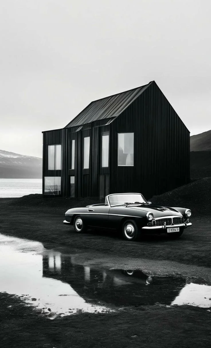 Modern b&w photo of modern house and fancy car