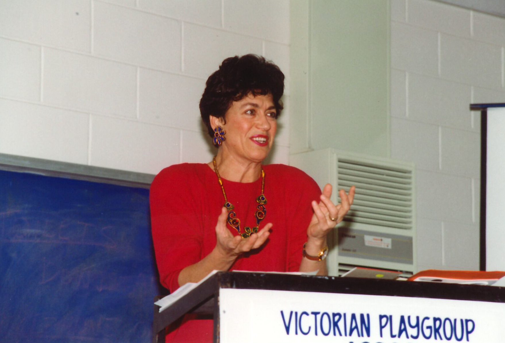 agm 93 - women in red speaking.png