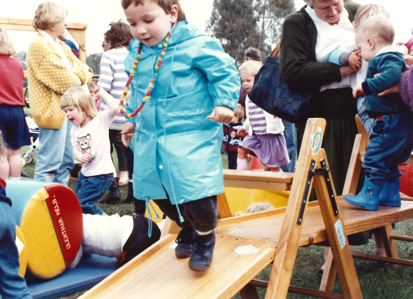 boy in blue raincoat on wood 2.png