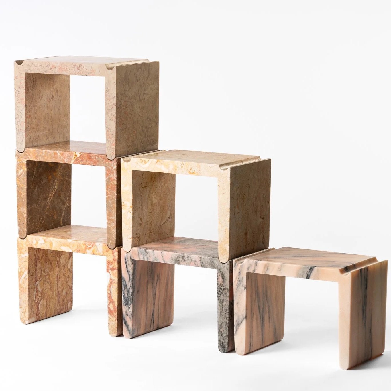 Stacked marble blocks arranged in a stepped pattern with varying colors and textures.