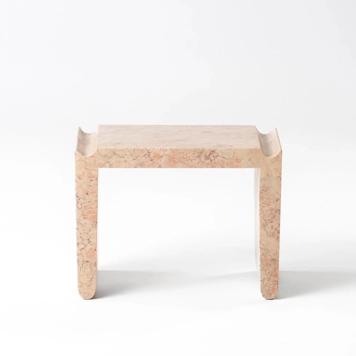 A minimalist wooden stool with a marble pattern finish, set against a plain white background.