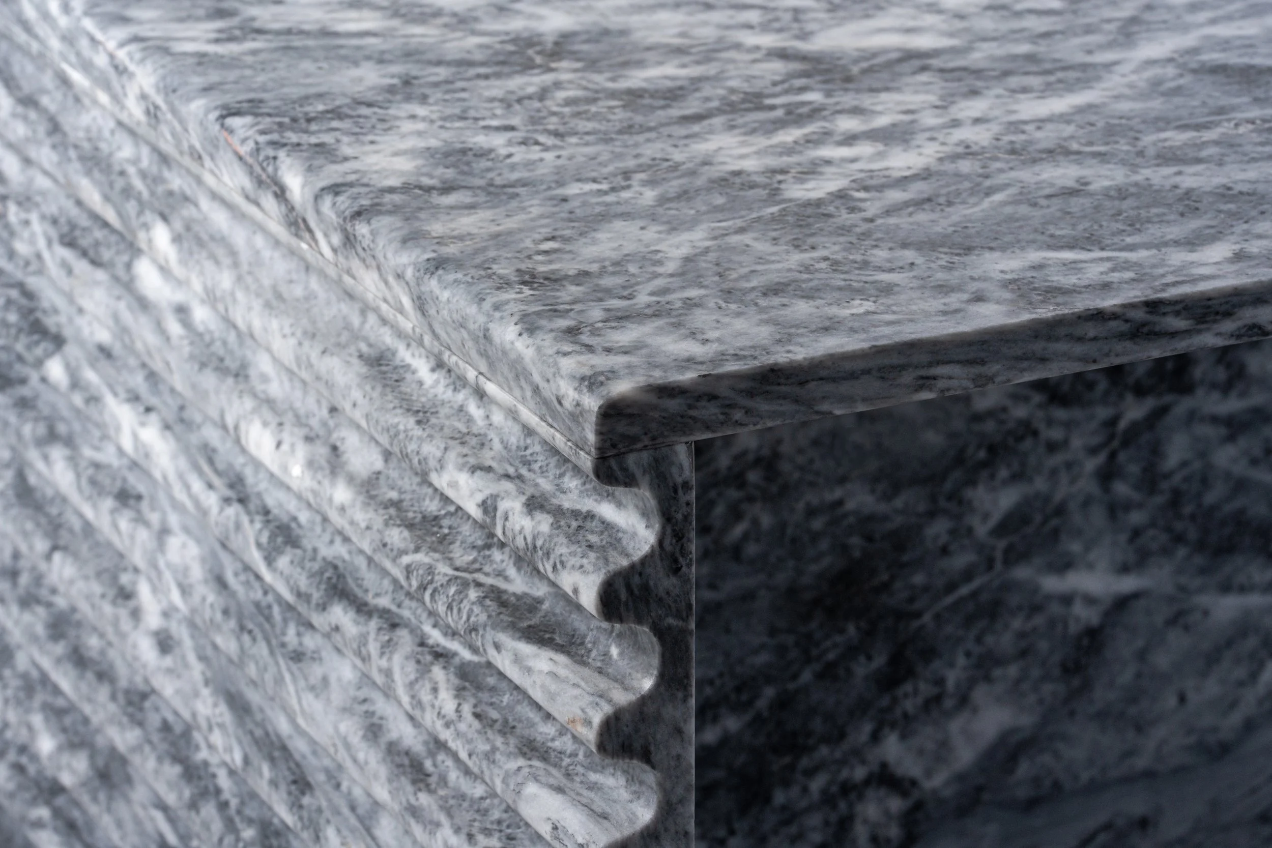 Close-up of a granite countertop with a polished, speckled gray and black pattern.