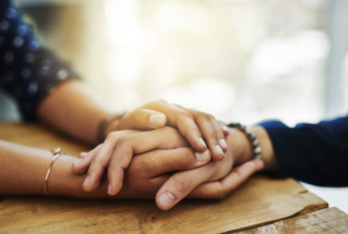 Hands held in comfort