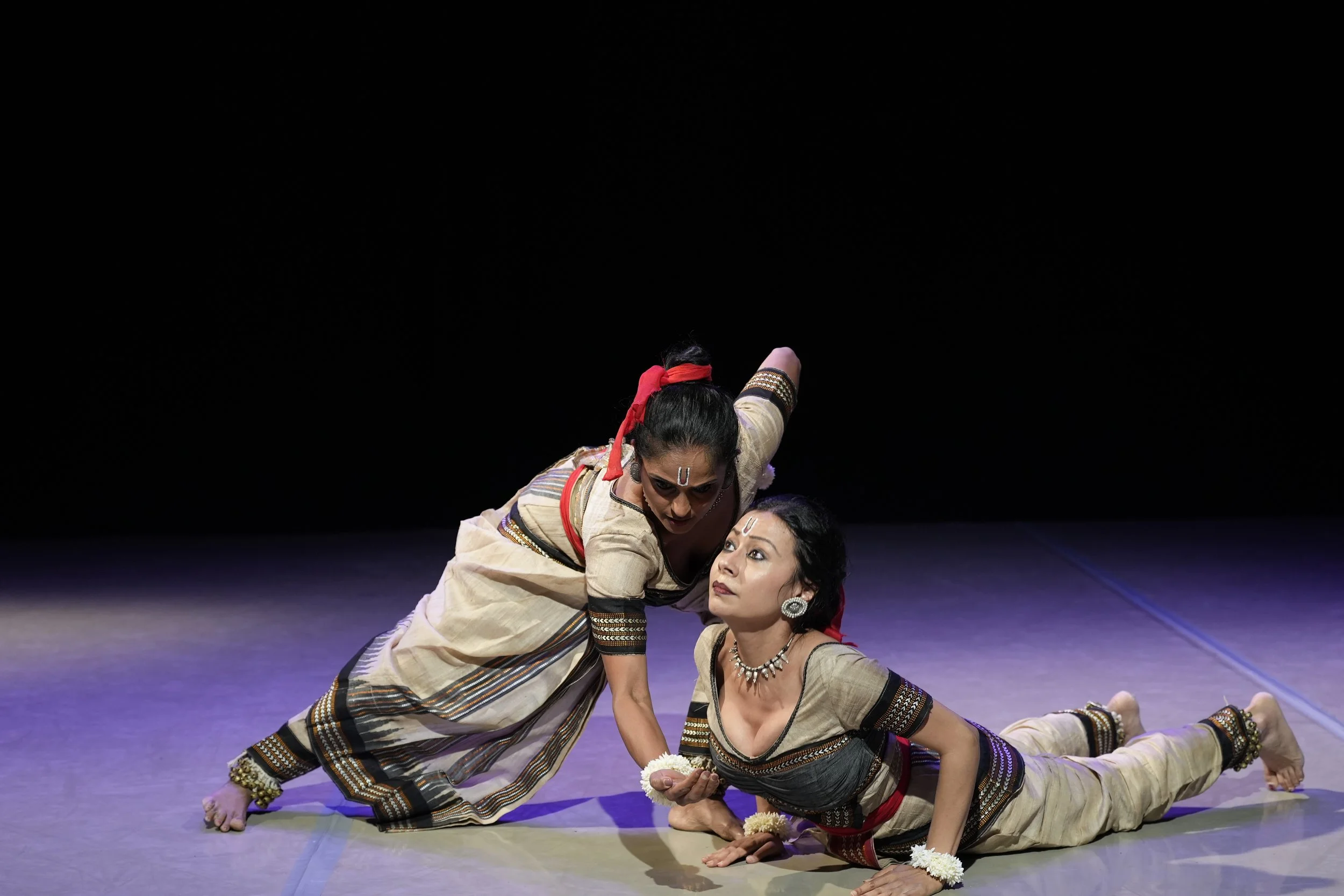 dancer with her head up and another dancer on stage