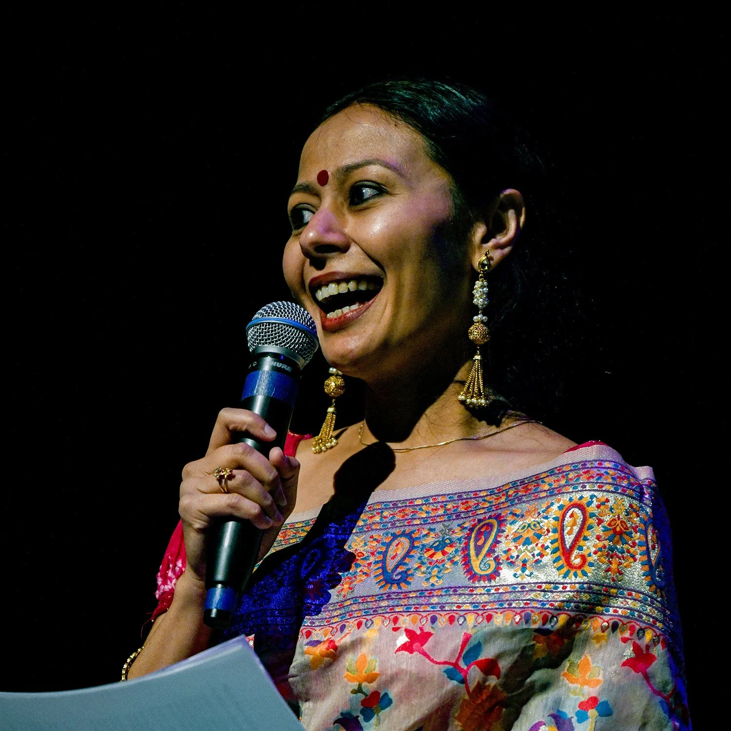 Kaustavi Sarkar on stage with a microphone
