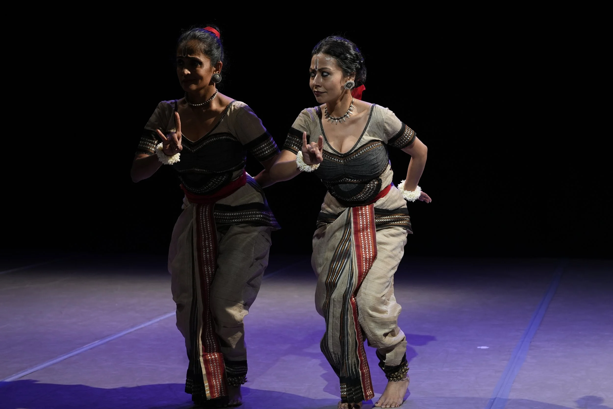 dancers with their fingers pointed up