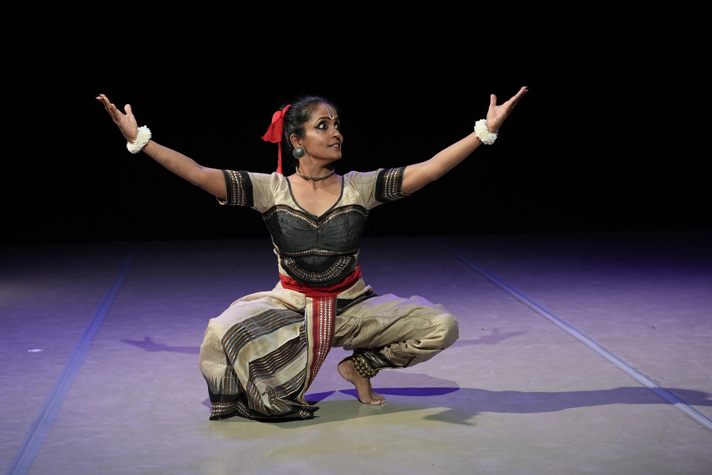 dancer with her arms outreached and in plie