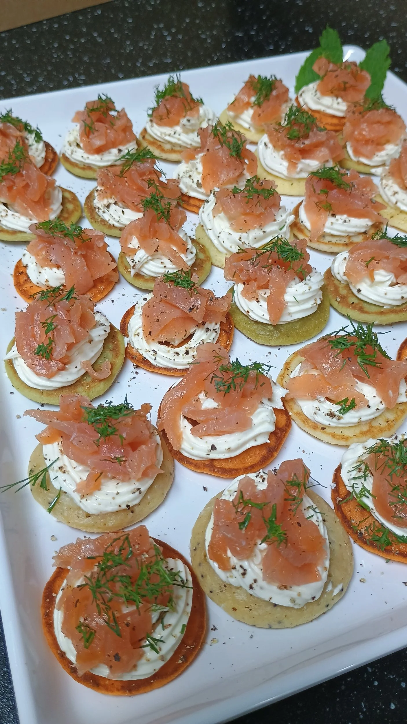 Blinis with cream cheese, smoked salmon, and chives