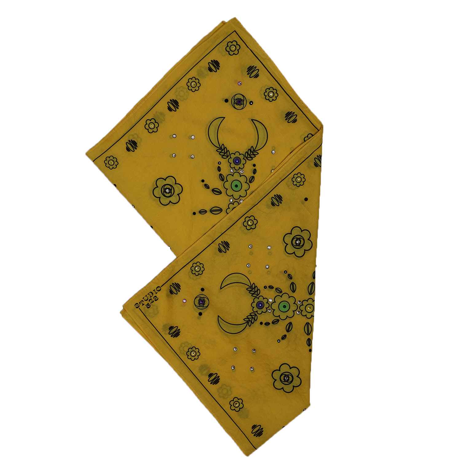 A yellow tarot card with black floral and moon designs, featuring a crescent moon, flowers, and small colored jewels, placed on a black and beige background.