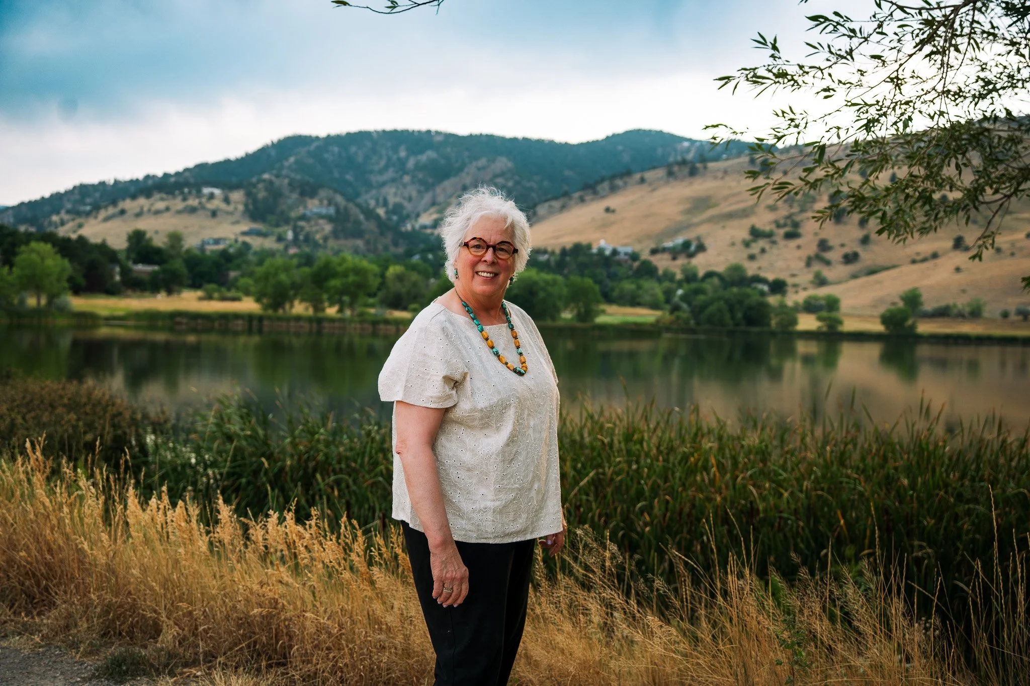 A woman posing at wonderland lake, a great spot for photos with water and mountains.