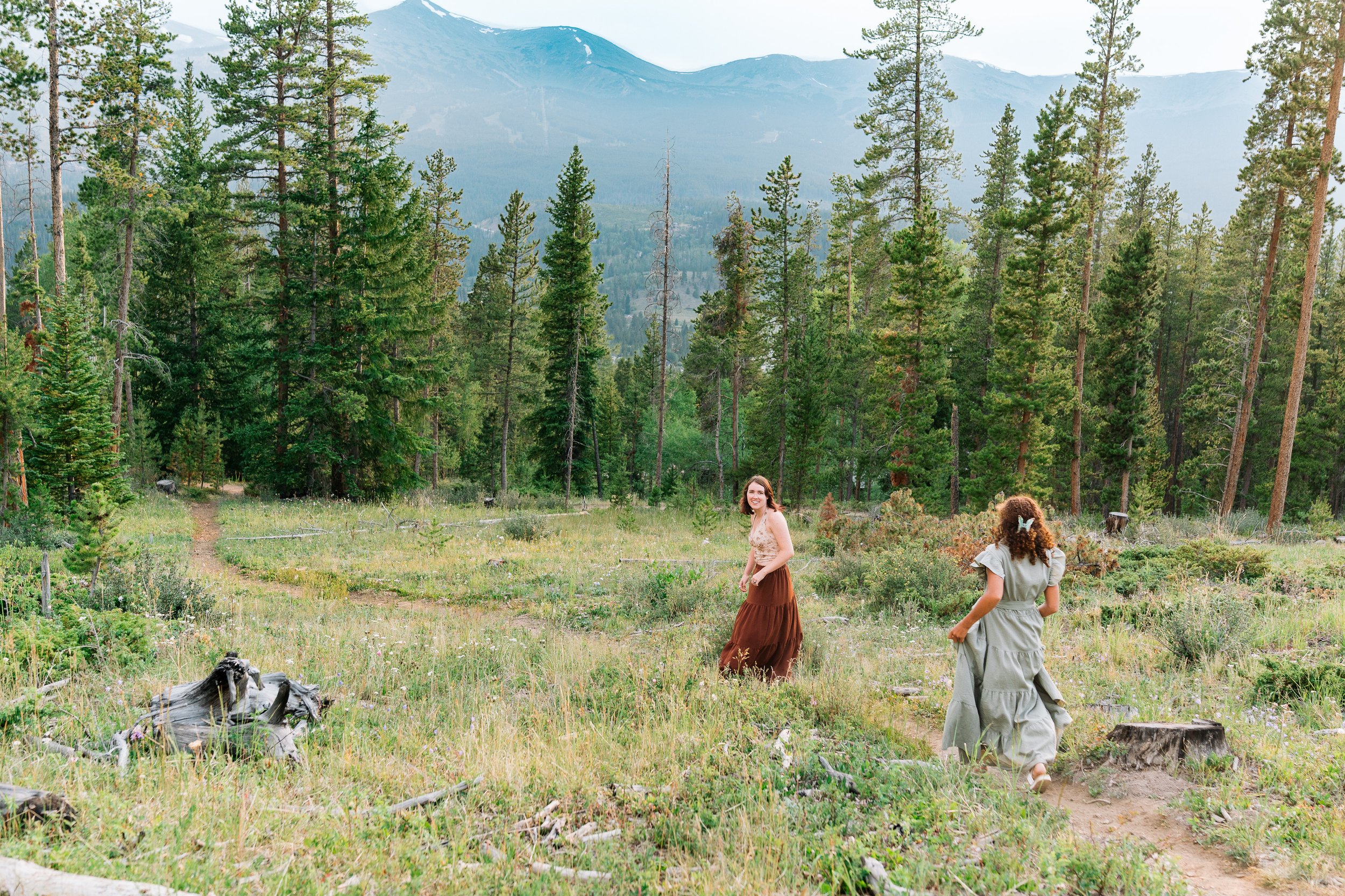 Family photo session with wildflowers and mountain views near Breckenridge, Colorado" — kept deliberately vague, no trail name, matching the tease