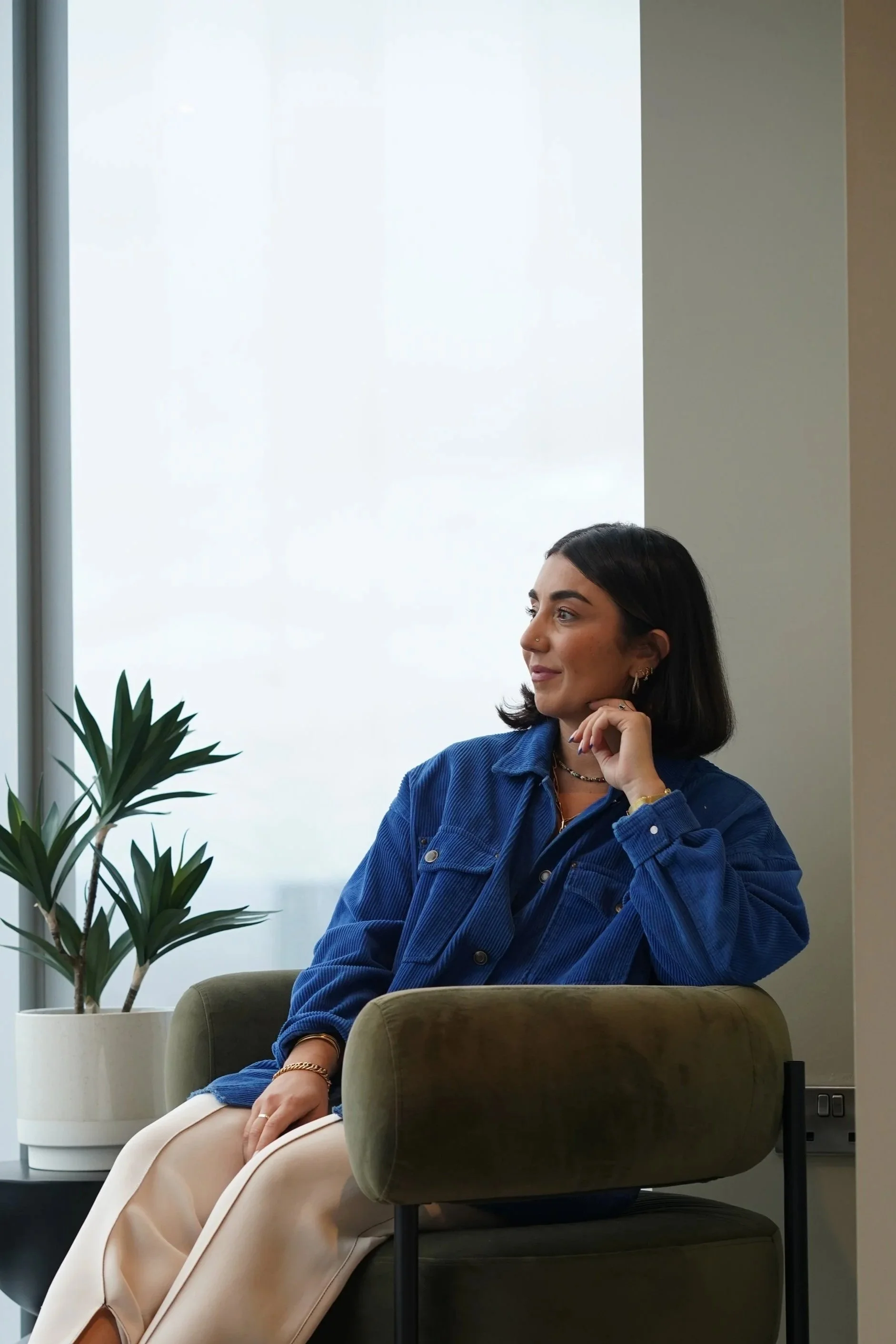 Alice Farkas-Toft, founder of Point North Consultancy, seated by a window in a relaxed, reflective setting.