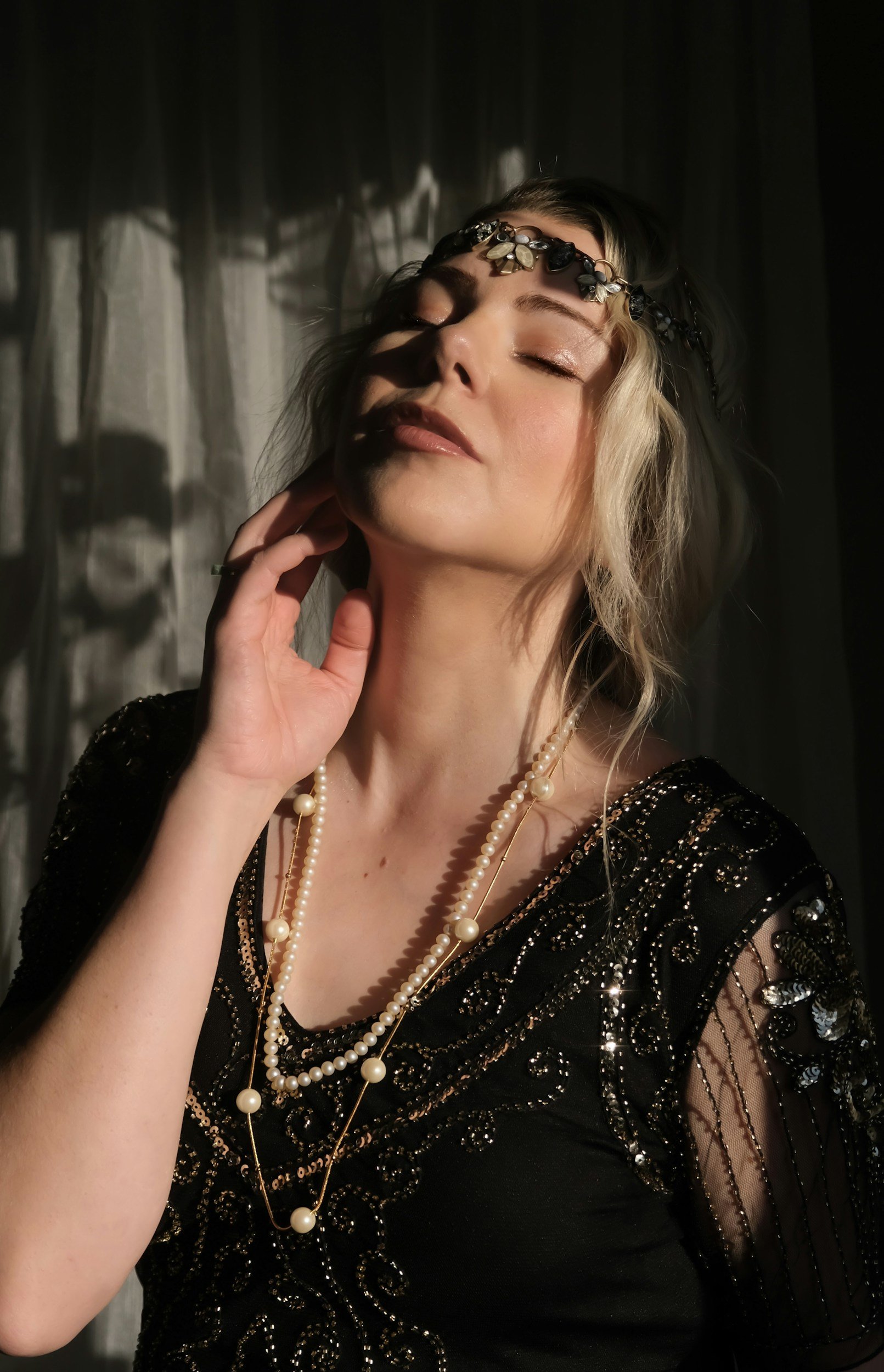 Elegant wedding reception hall decorated with large floral arrangements, hanging floral installations, and candlelit tables under a floating floral chandelier.