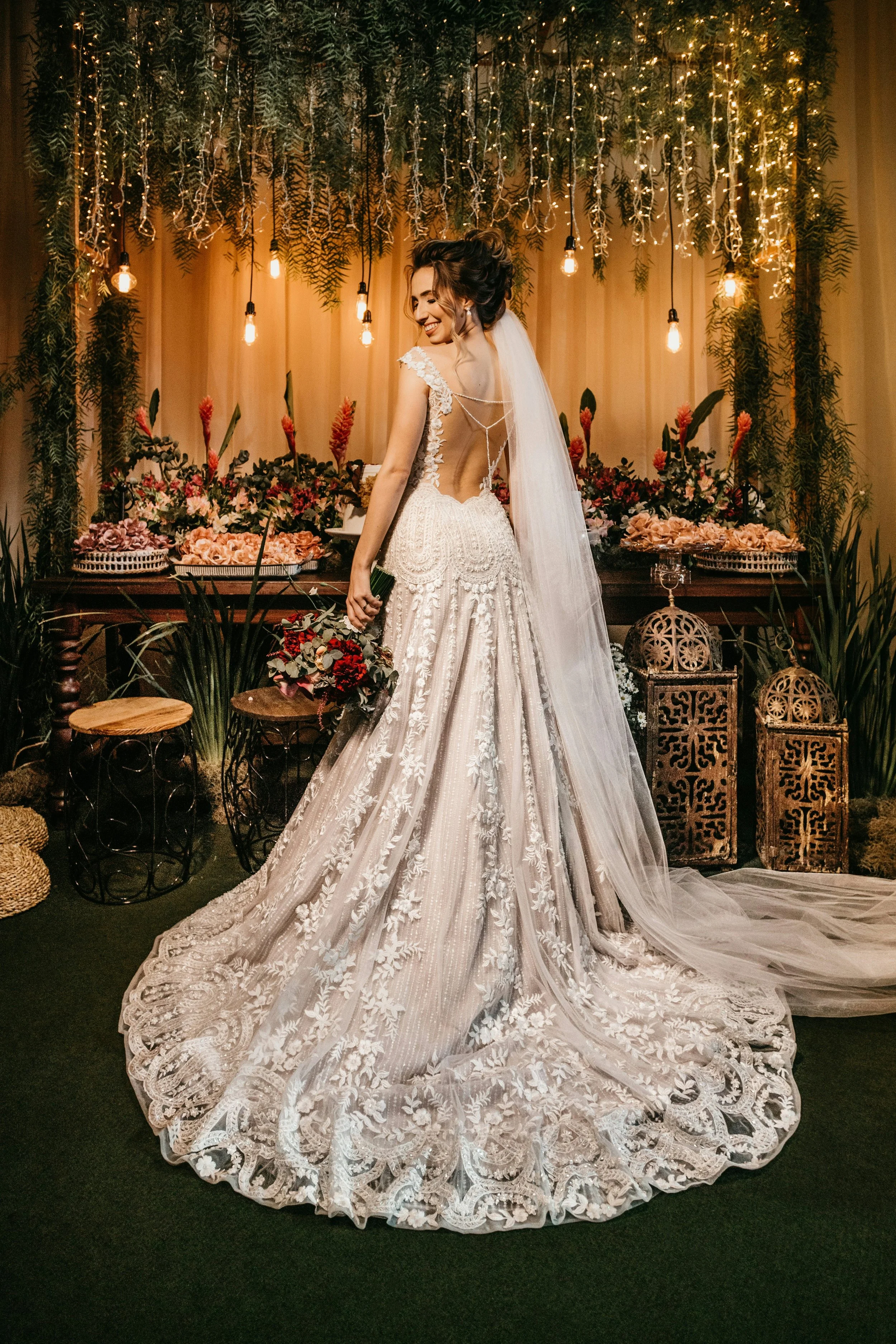 Bride in embroidered dress infront of dessert station