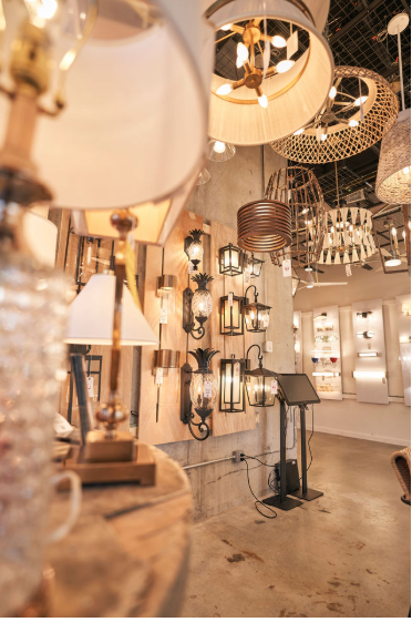 Store interior with various modern pendant and wall-mounted light fixtures displayed on the walls, including lamps with different shades and designs.