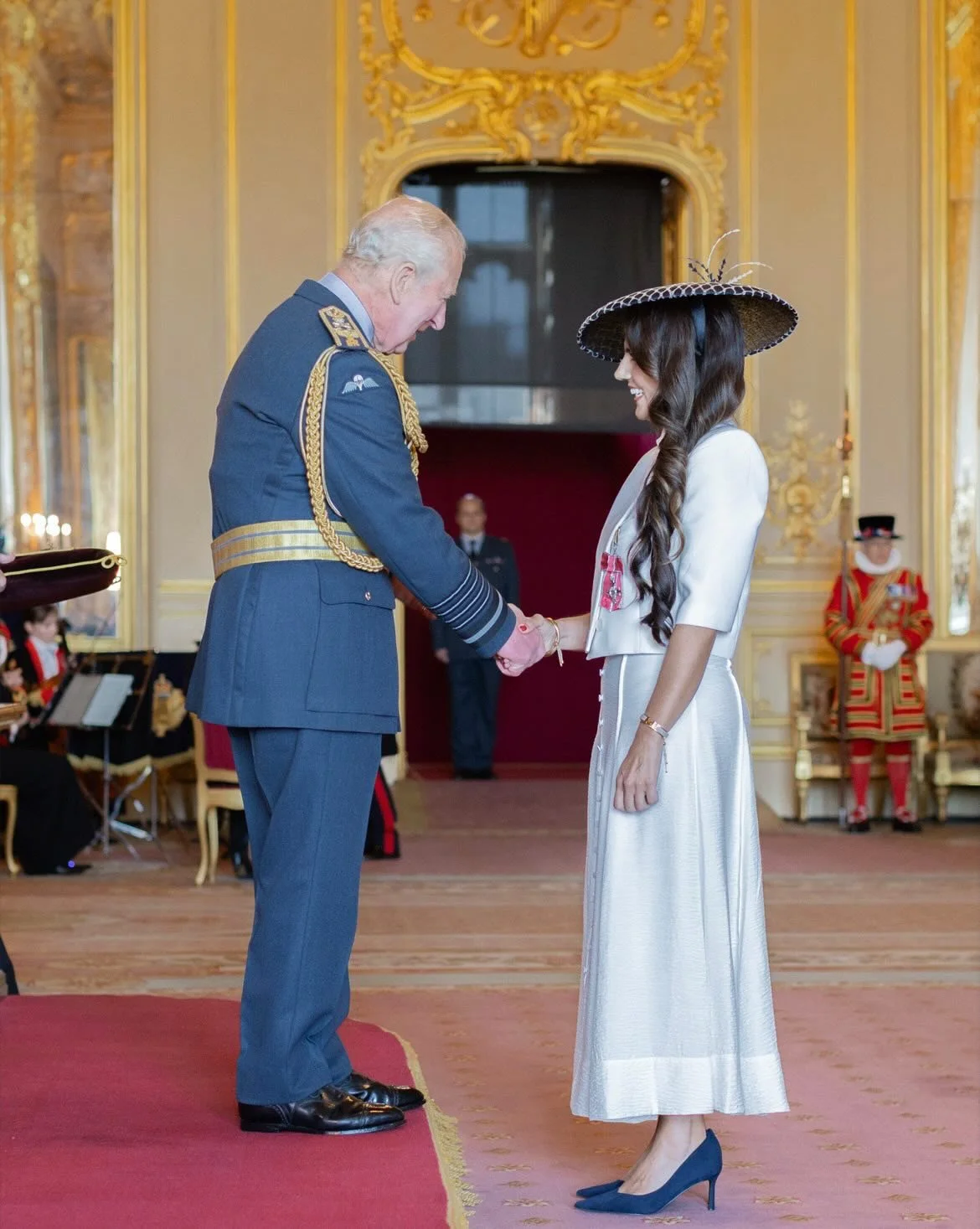 Dr Dominique Allwood receives an MBE wearing Rachel Skinner Millinery