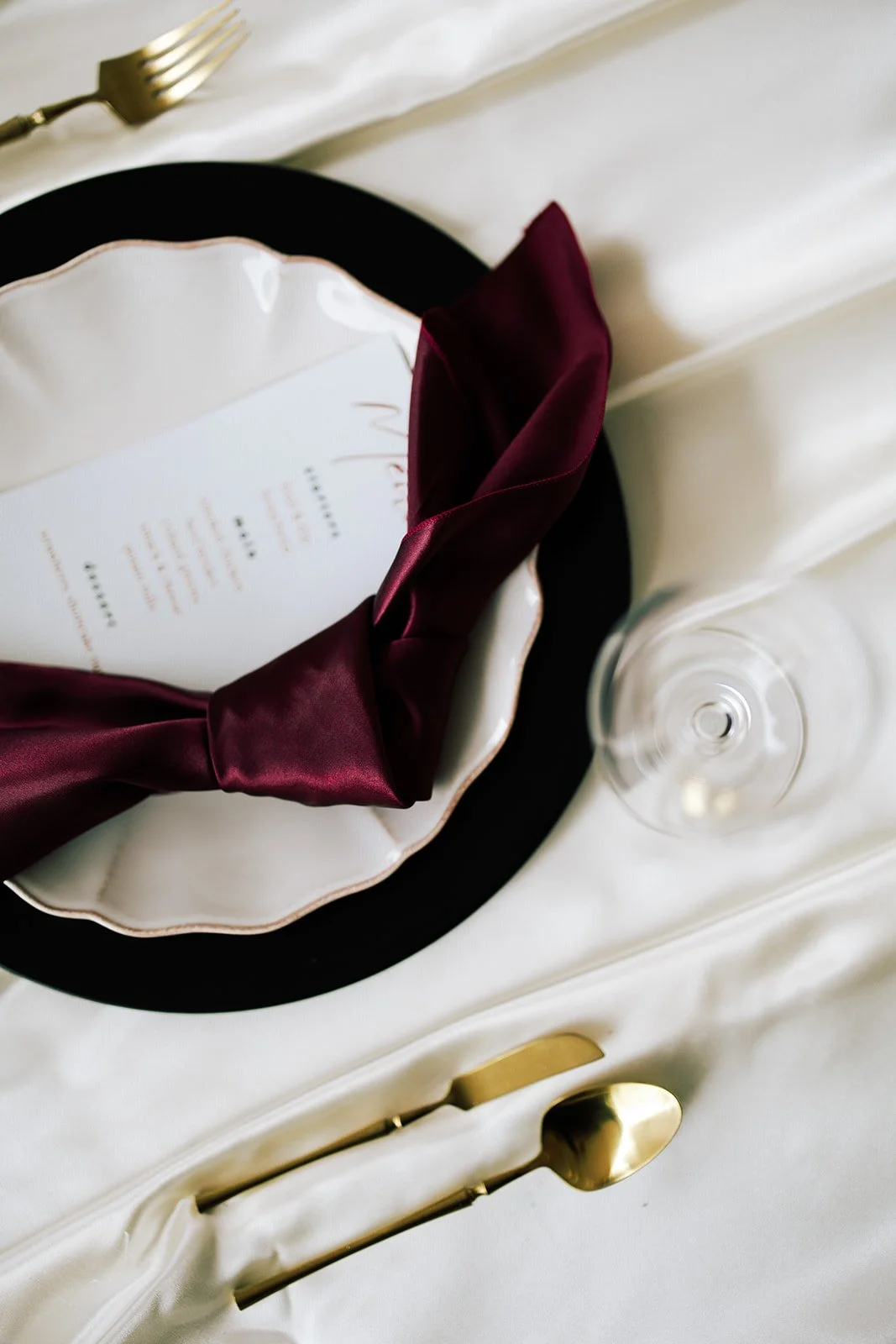 a burgundy and white place setting at a wedding in virginia beach