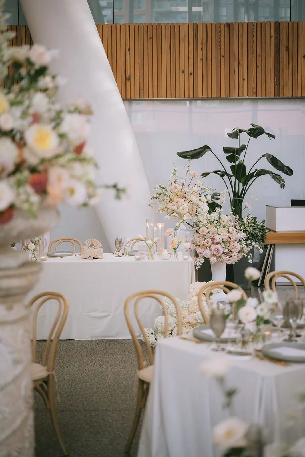 Head table at a luxury Hindu wedding at Ricarda's Toronto with abundant blush and white floral installations, soft candlelight, and a minimalist reception design.