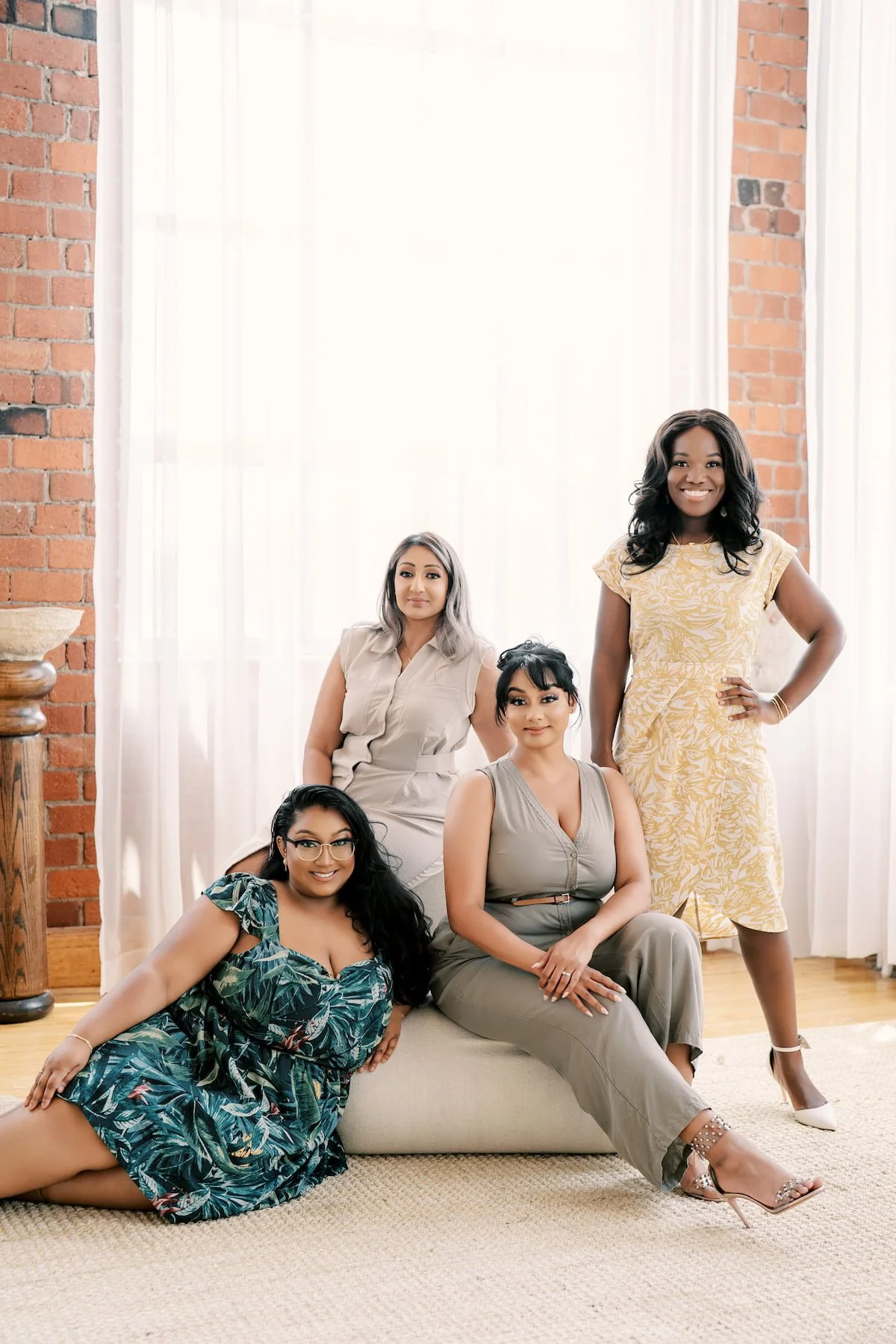 The Events by Whim wedding planning team posing together in a bright Toronto studio.