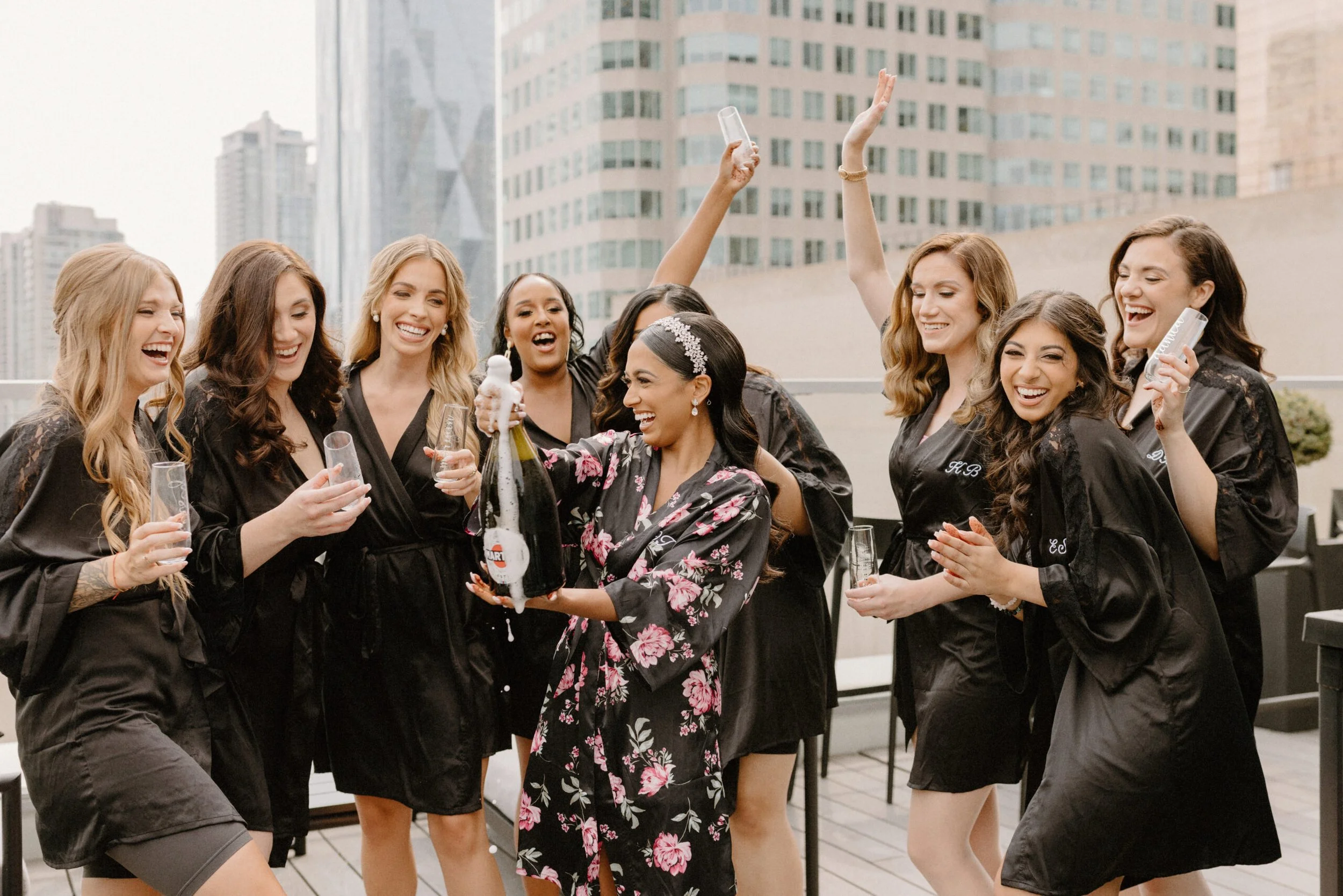 Bride enjoying a relaxed wedding morning At One King West while getting ready with her bridesmaids before her ceremony.