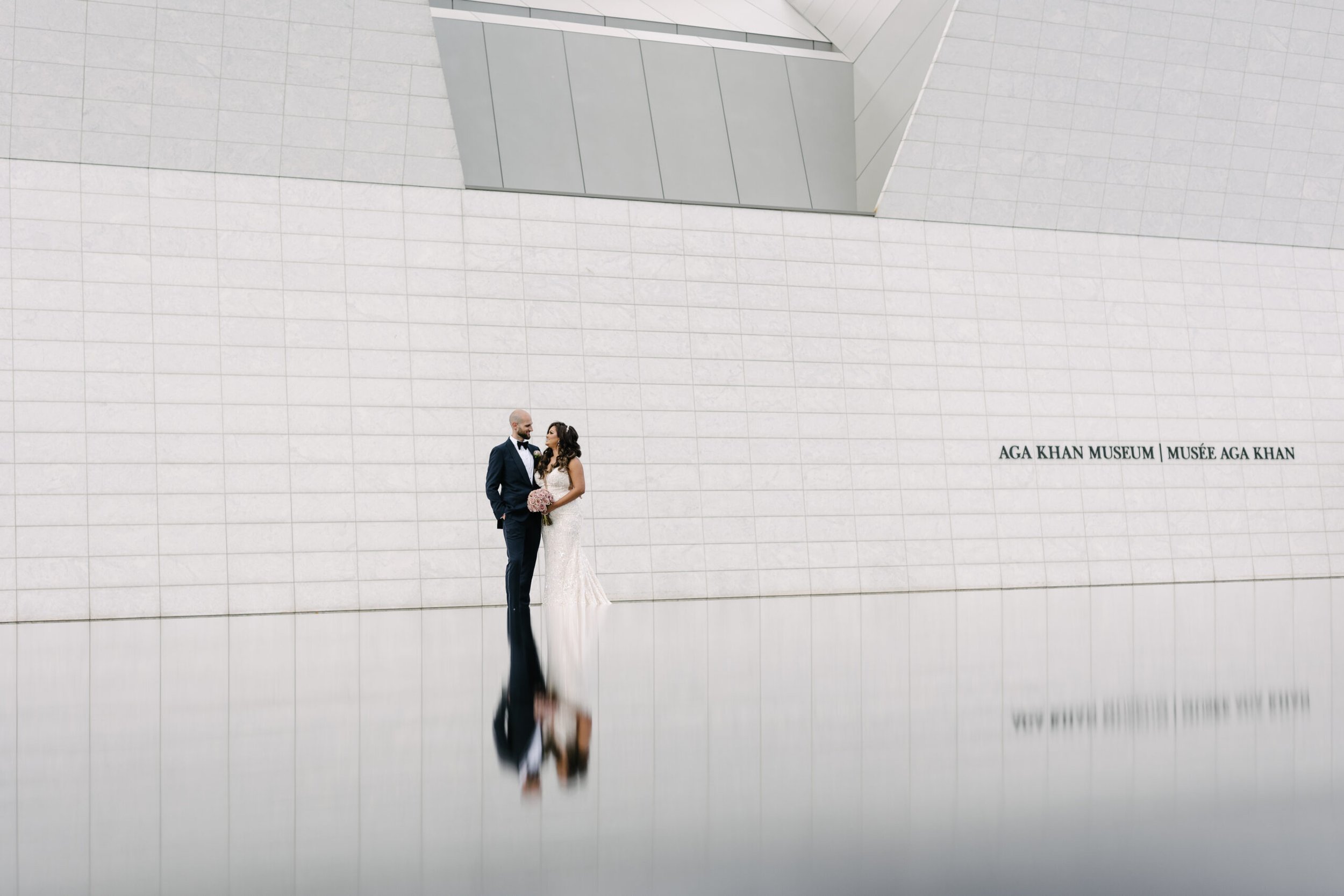 Newly married couple sharing a private moment together after their wedding ceremony before joining cocktail hour at the Aga Khan Museum