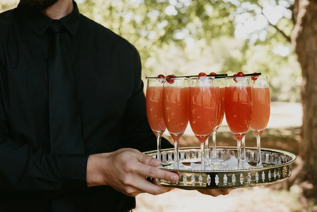 Newly married couple celebrating with guests during cocktail hour at a luxury Belcroft Estate wedding planned by Events by Whim.