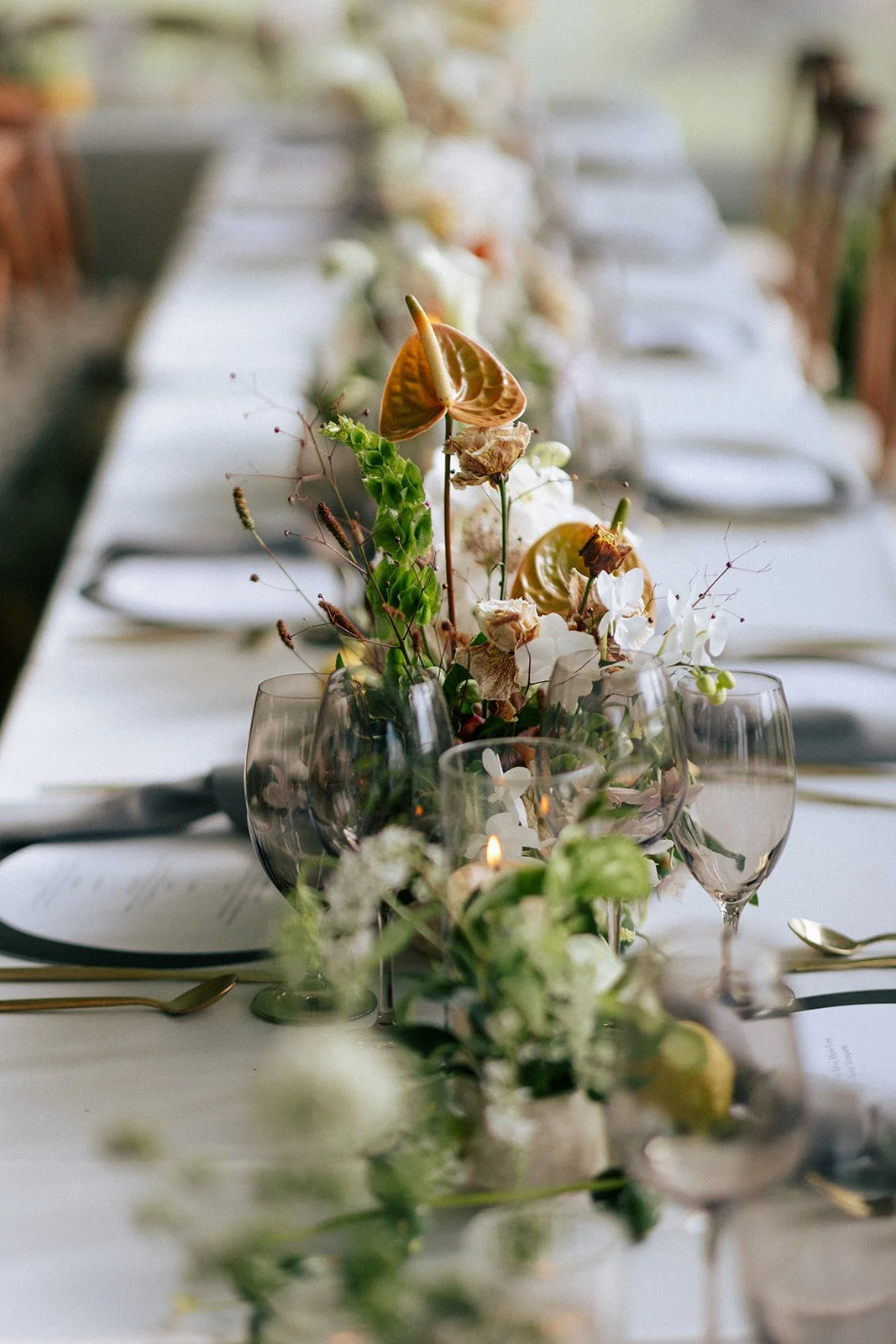 Elegant luxury wedding reception table with layered place settings, romantic florals, candlelight and thoughtful guest-centred design.