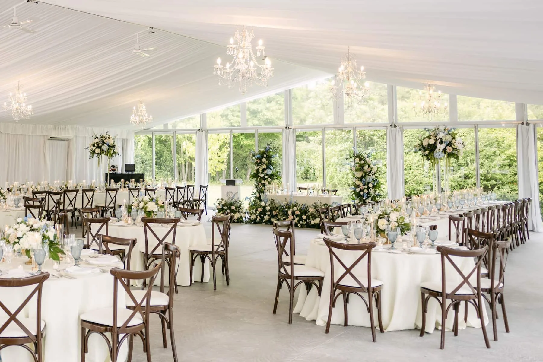 Elegant garden-inspired wedding reception inside a sailcloth tent at Harding Waterfront Estate featuring lush floral design and candlelight.