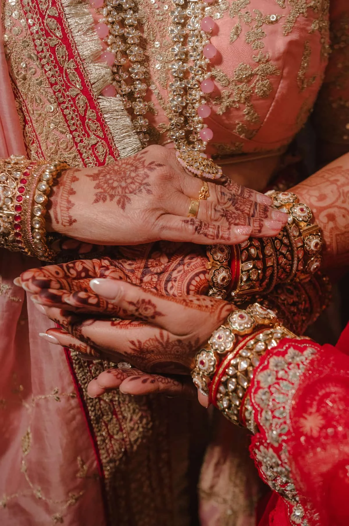 Close-up of Ashika's mehndi, bridal jewellery, and bangles during her South Asian wedding ceremony at Arlington Estate.