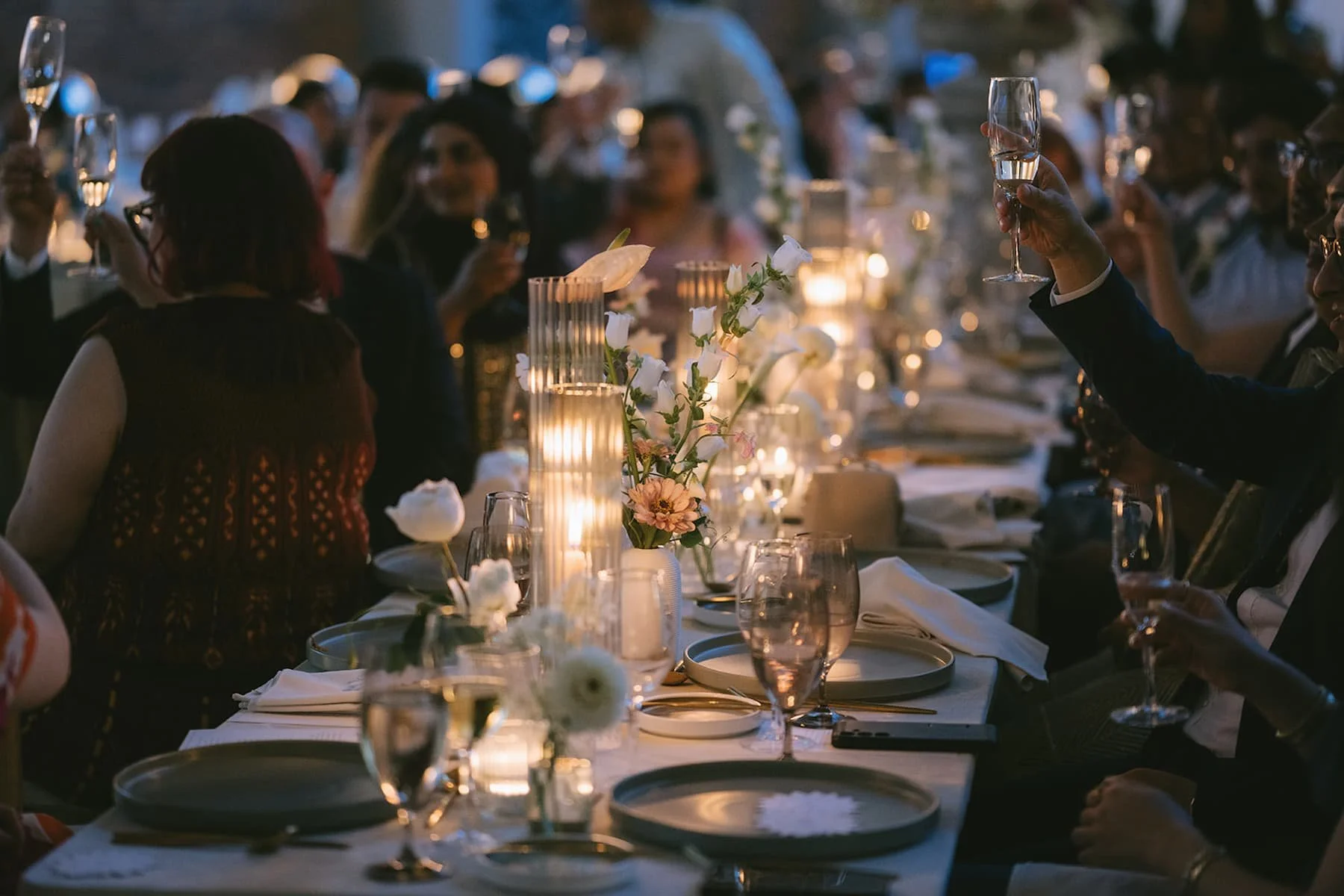 Couple celebrating during their wedding reception at Ricarda's Toronto surrounded by family and friends.