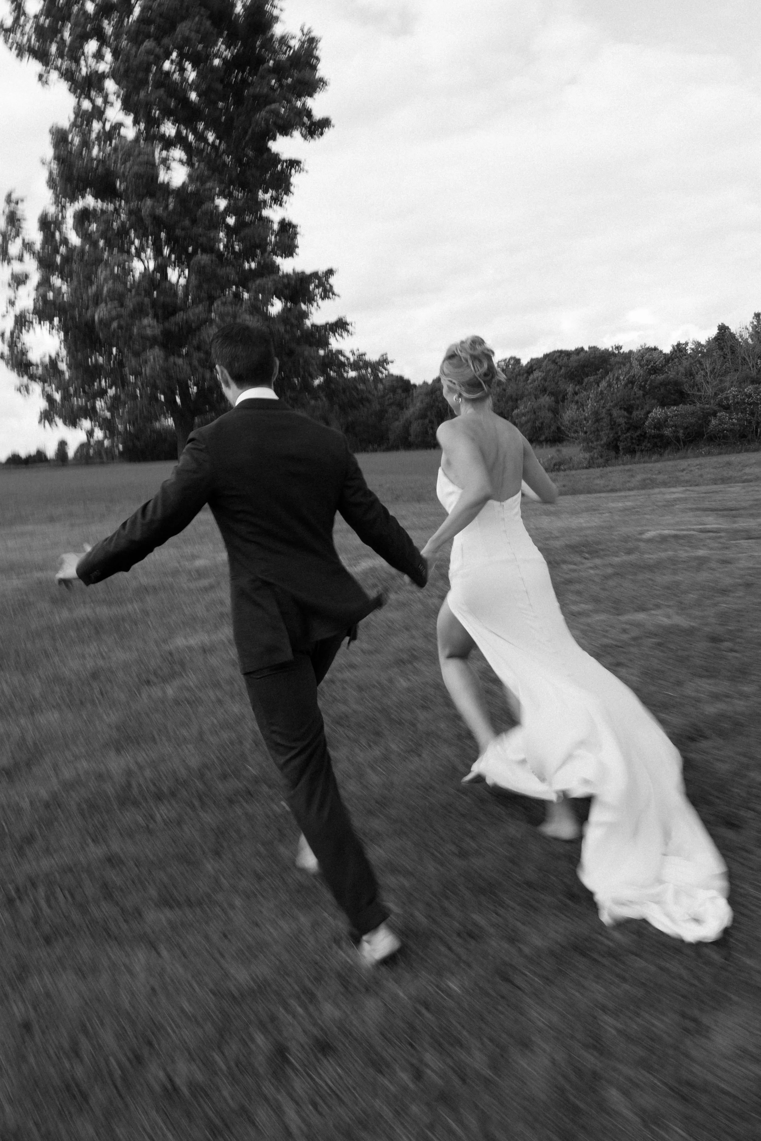 Newly married couple walking hand in hand through the grounds of Lune 1860 after their wedding, planned by Toronto wedding planners Events by Whim.