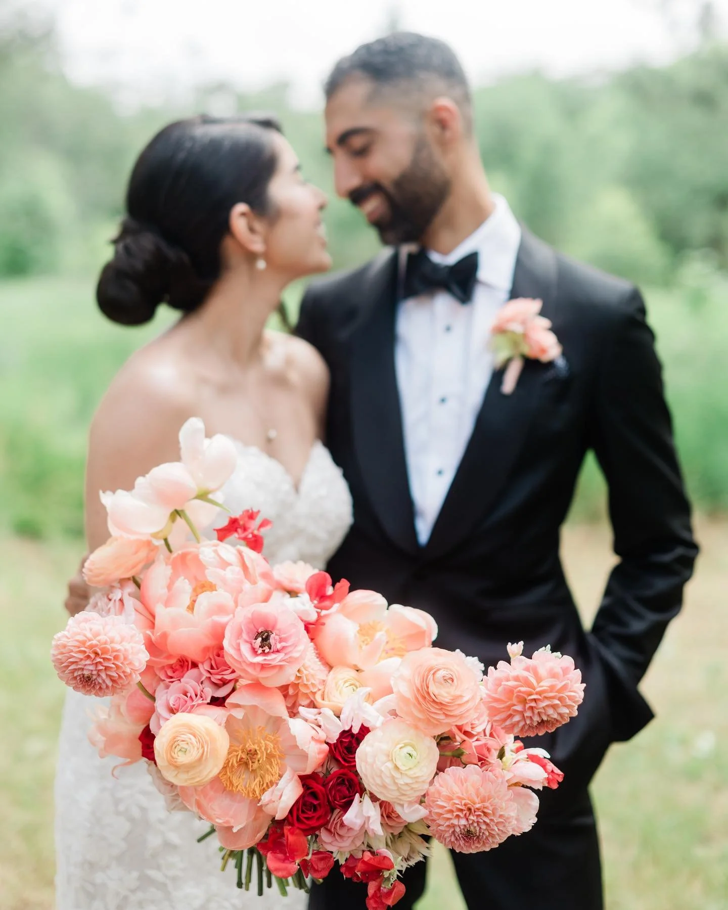 Bride and groom sharing a quiet moment at Three Feathers Terrace, holding a vibrant bridal bouquet during a wedding planned by Events by Whim.