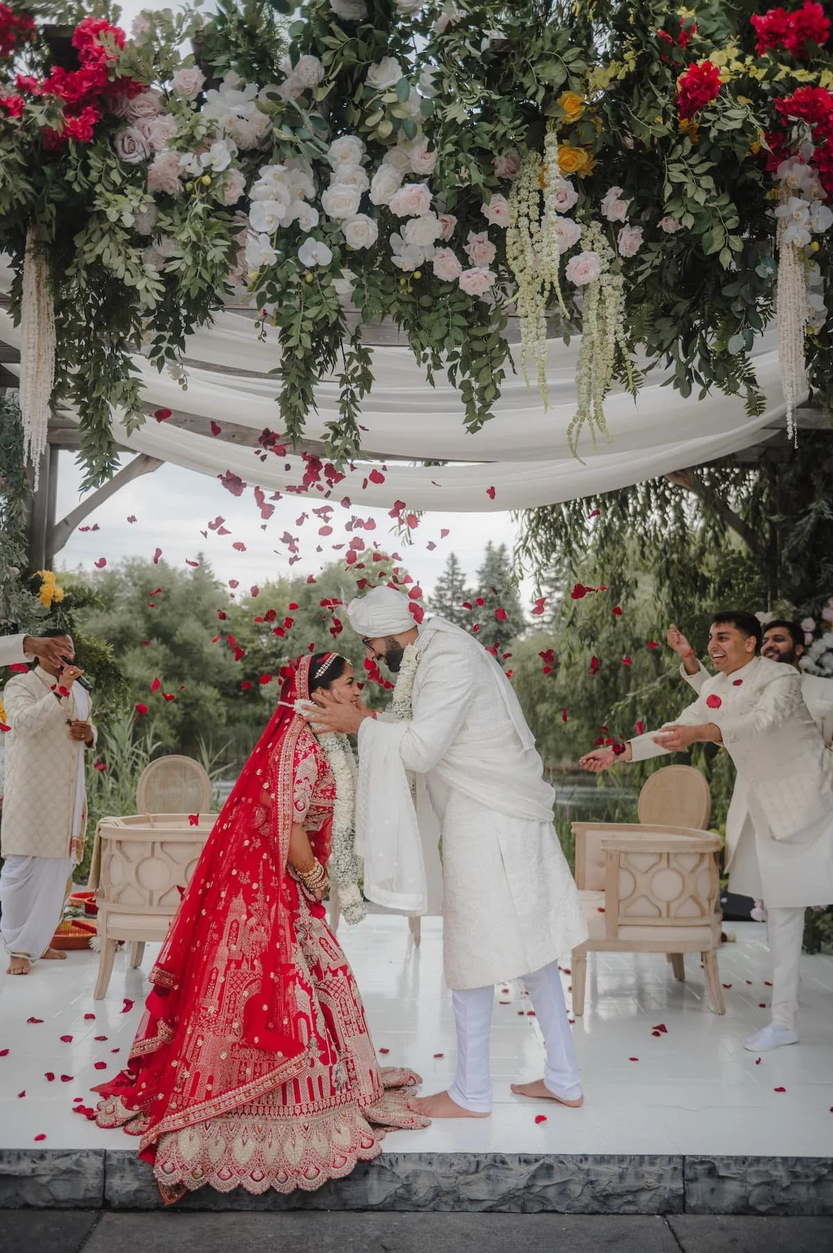 Ashika and Sagar during the varmala ceremony beneath a floral mandap at their outdoor Hindu wedding at Arlington Estate.