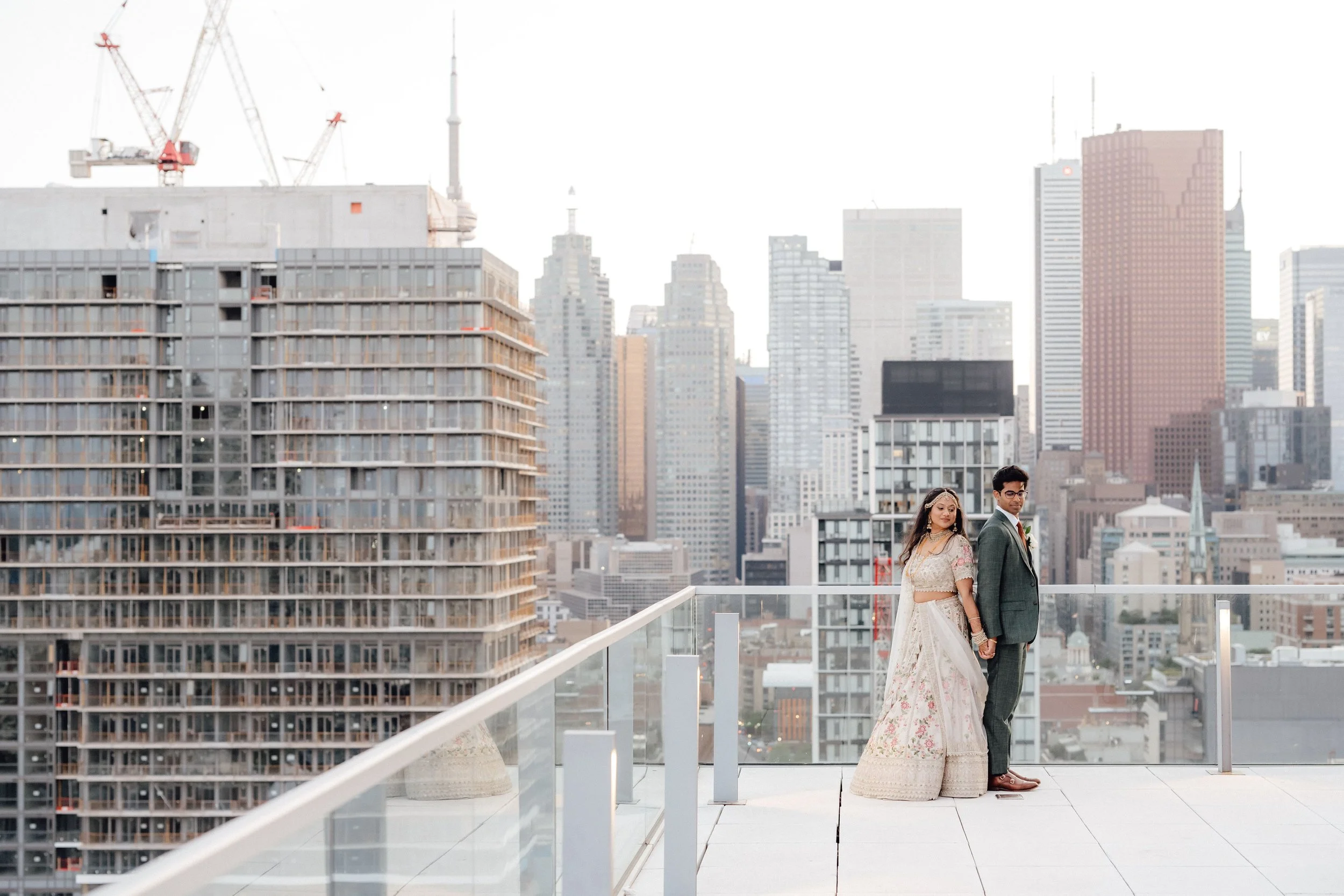 Couple sharing a first look before their multicultural wedding at the Globe and Mail Centre in Toronto.