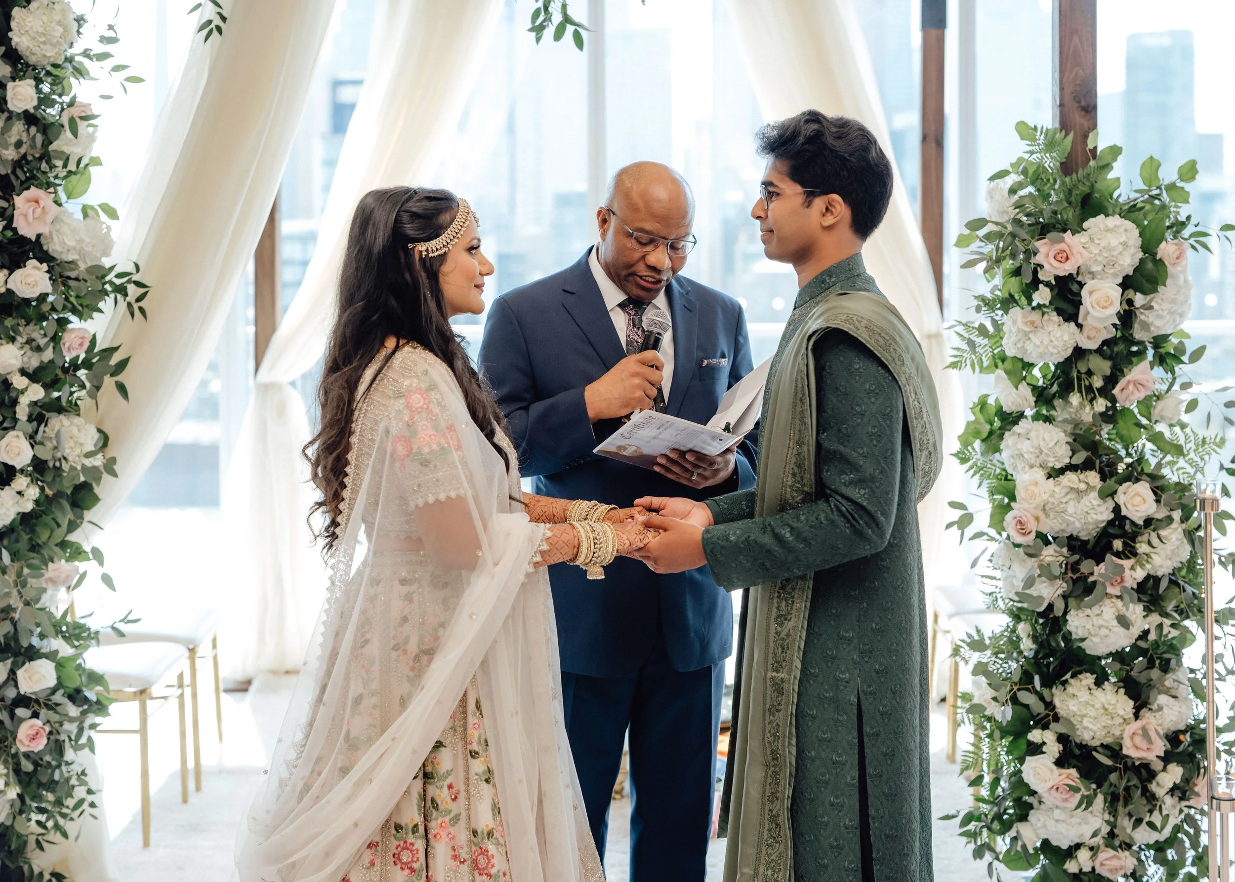 Christian and Hindu wedding ceremony at the Globe and Mail Centre in Toronto, with a floral mandap and guest seating.