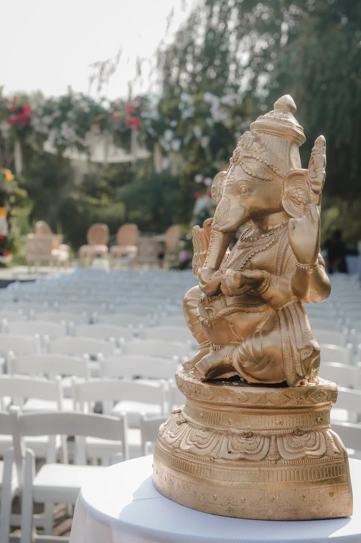 Golden Ganesha statue overlooking the ceremony space before Ashika and Sagar's outdoor Hindu wedding ceremony at Arlington Estate.
