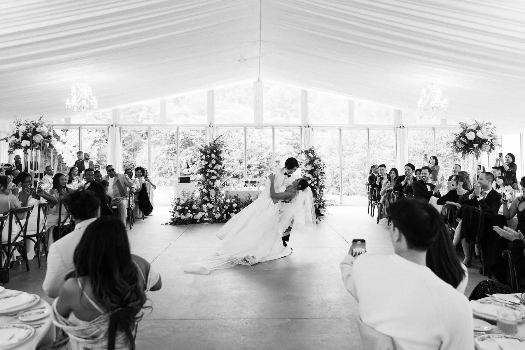 Bride and groom share their first dance surrounded by family and friends at Harding Waterfront Estate.