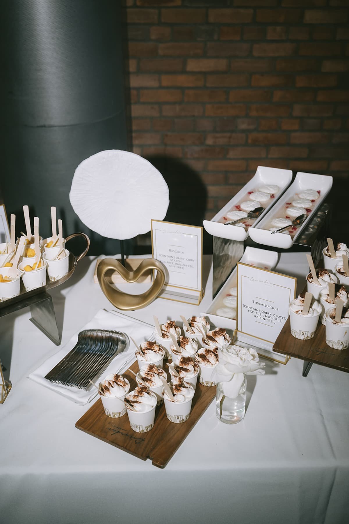 Elegant wedding dessert station featuring tiramisu cups, rasgulla and plated desserts at a luxury reception at Ricarda's Toronto.