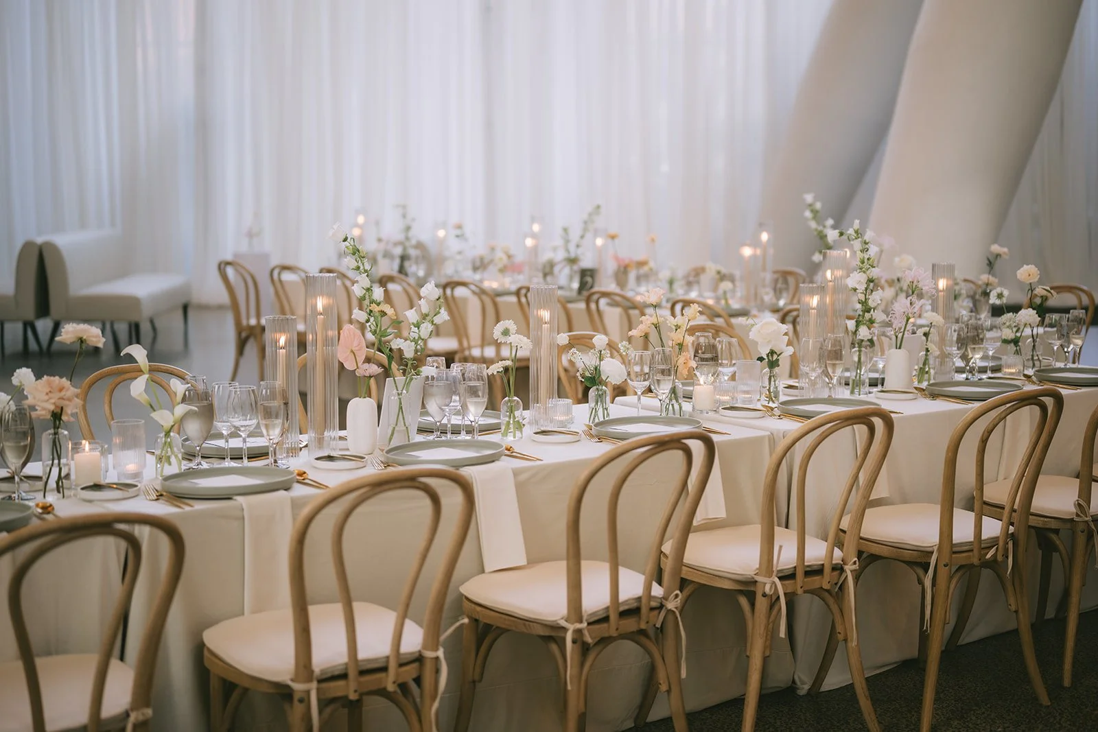 Luxury wedding reception reveal featuring candlelight, fresh florals and elegant lighting designed by Events by Whim at Ricarda's in Toronto.