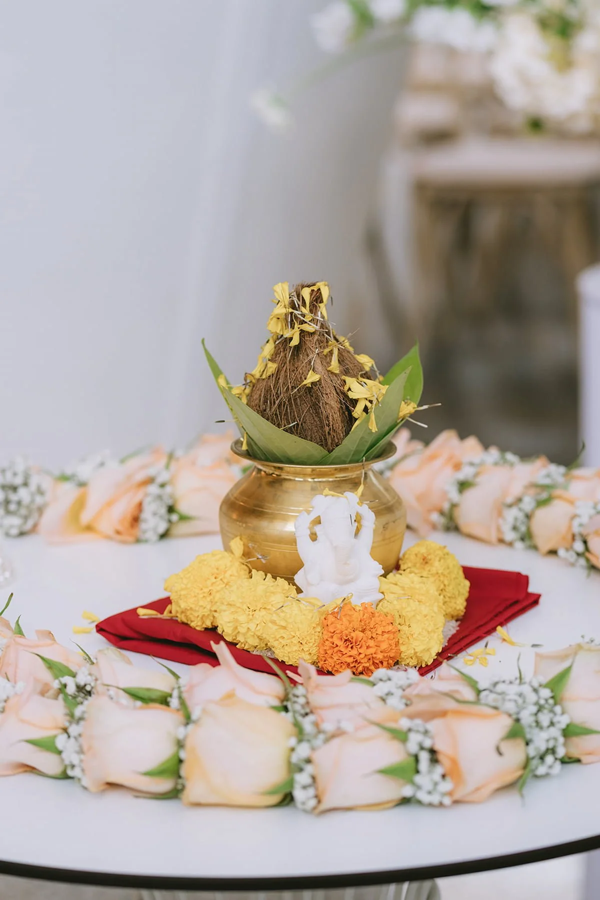 Traditional Hindu wedding kalash with coconut, Lord Ganesha, marigolds, and roses prepared for the ceremony at Ricarda's in Toronto.