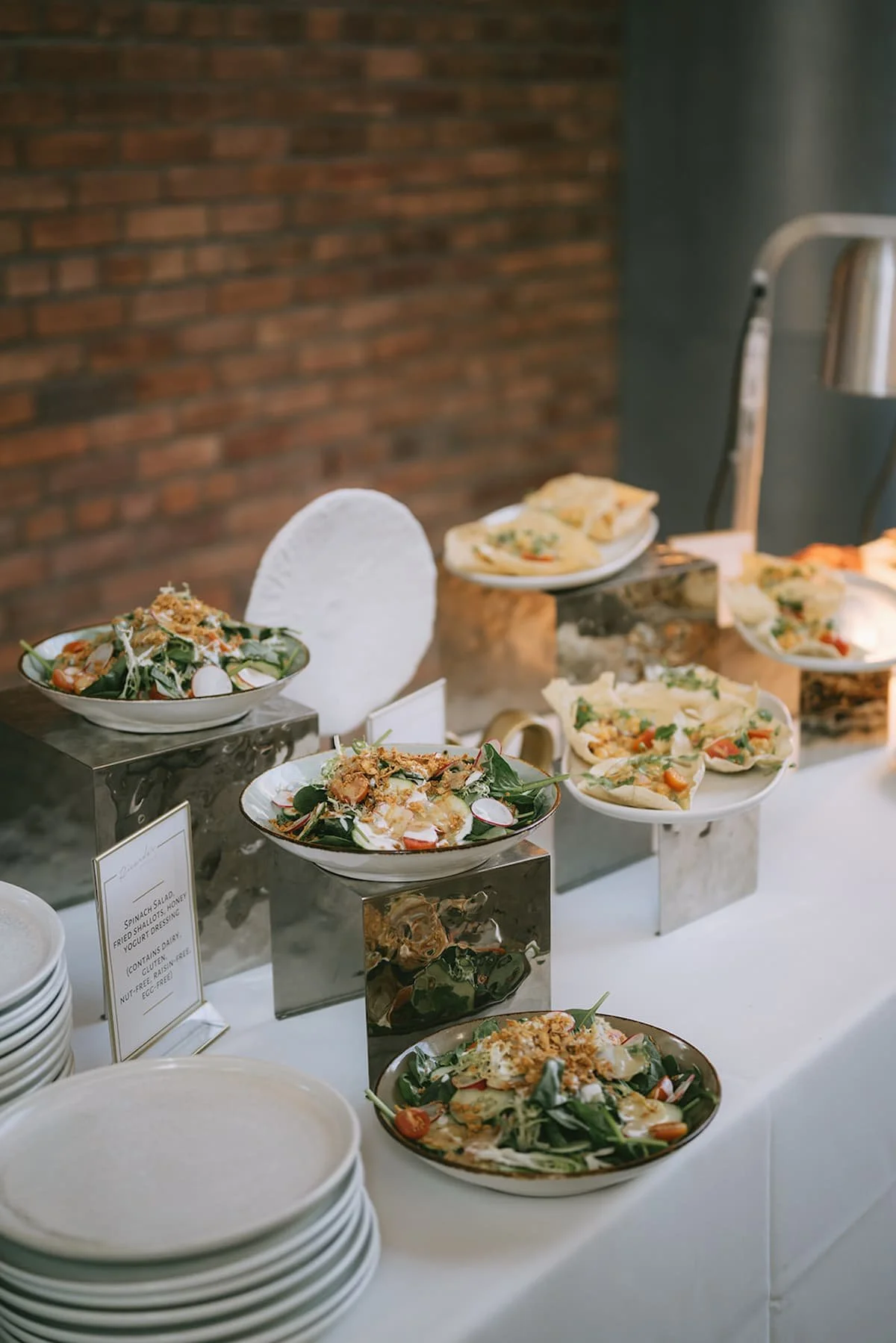 Beautifully presented cocktail hour display with fresh salads and passed hors d'oeuvres at a luxury wedding reception at Ricarda's Toronto.