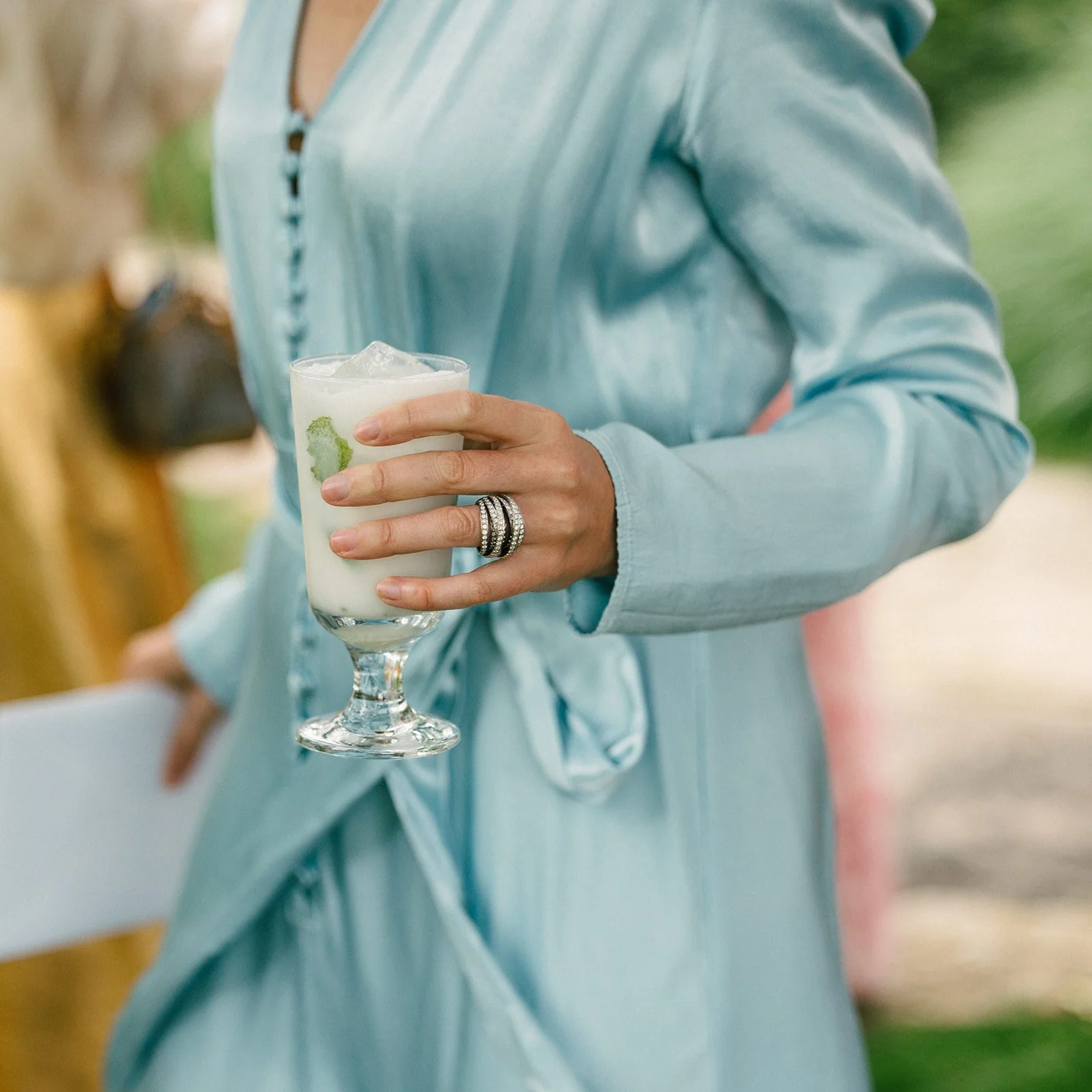 Bride and groom mingling with guests during cocktail hour at a luxury wedding reception.