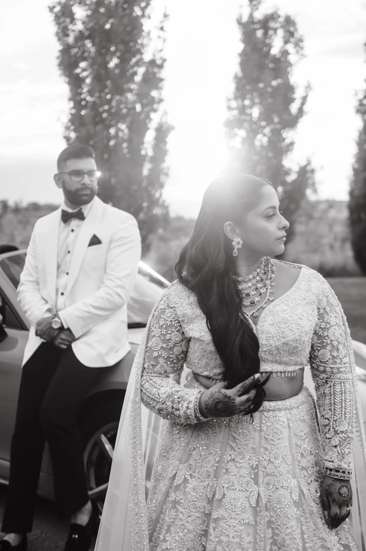 Editorial black-and-white portrait of the bride and groom in their white reception attire during sunset portraits at Arlington Estate in Ontario.