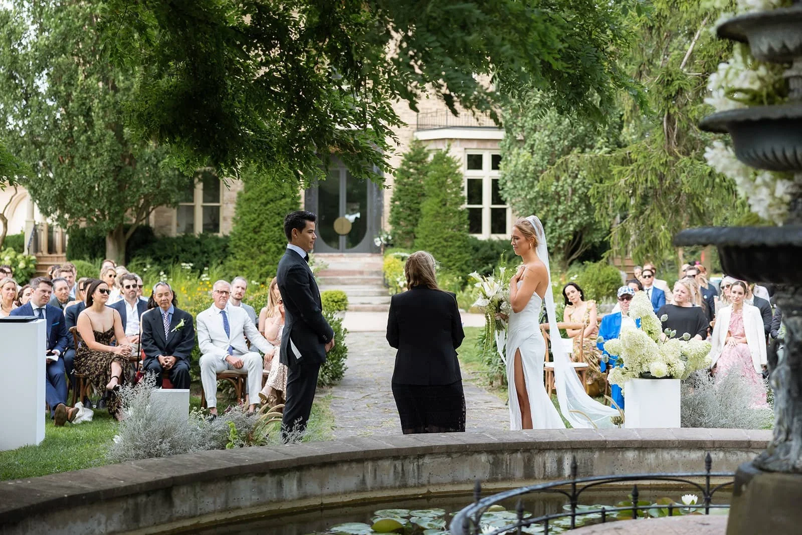 Couple during vow exchange during an outdoor wedding ceremony at Lune 1860 in Ontario.