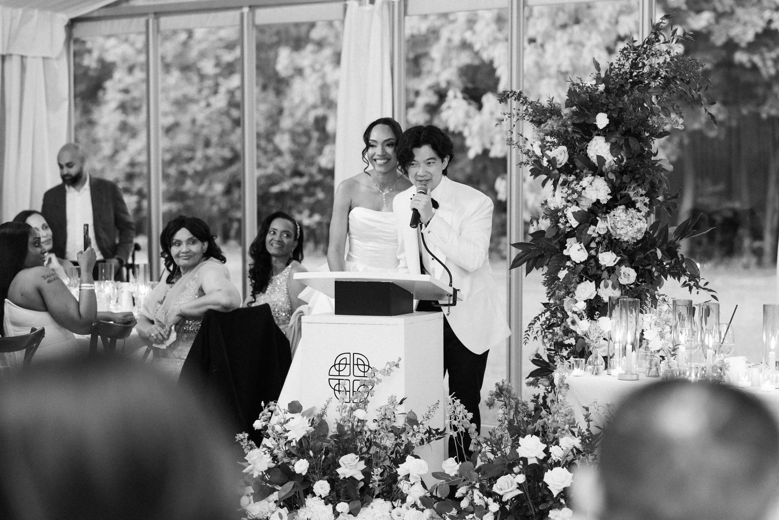 Wedding guests enjoying dinner and conversation at an elegant reception at Harding Waterfront Estate planned by Events by Whim, showcasing thoughtful hospitality and guest comfort.