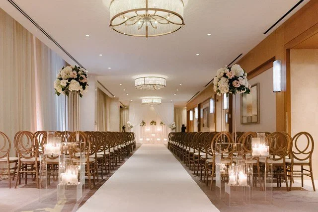 Wedding ceremony in the Grand Foyer at The Ritz-Carlton, Toronto with a modern floral ceremony design.