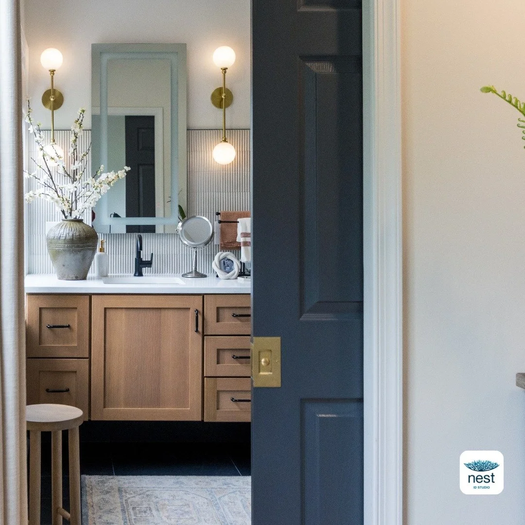 What greets you when you start your day?

Your surroundings set the tone&mdash;calm, chaotic, or something in between. 

A glimpse behind this pocket door reveals a serene primary bath where layered lighting, warm wood tones, and tonal textures come 