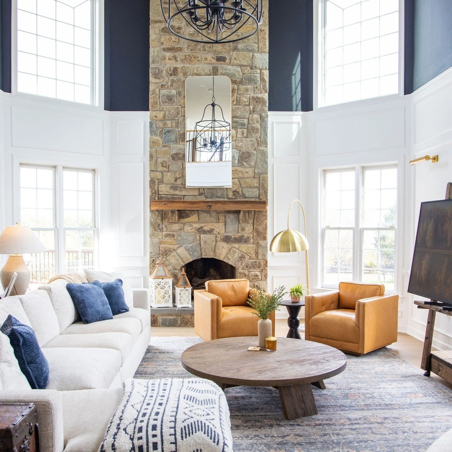 Sometimes the magic is in the details-and sometimes it is in seeing how they all come together.

These wider views show how layered moulding, intentional color placement, and thoughtful furnishings transform a two-story volume into a space that feels