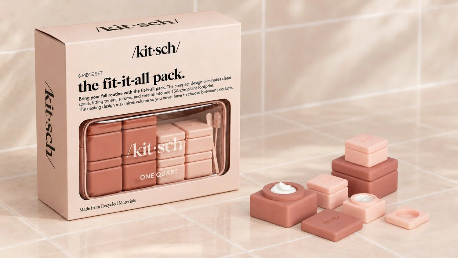 Kitsch Fit-It-All Pack box with a clear pouch of pink containers and loose containers beside it